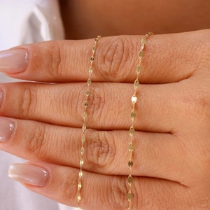 Macro shot of ultra-fine gold S925 sterling silver snake chain with flat scale links