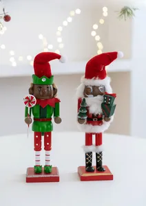 Detail of wooden Nutcracker soldier set with Santa and Elf figures on red bases