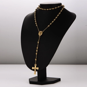 Golden stainless steel rosary necklace with crucifix and virgin mary medallion on mannequin