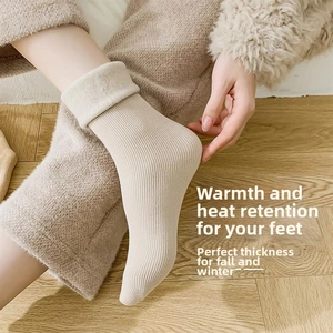 Detail showing thick beige knit winter socks with plush faux fur cuffs on wooden floor