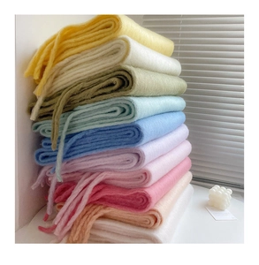 Macro display of thick mohair scarves in yellow white green blue and pink shades