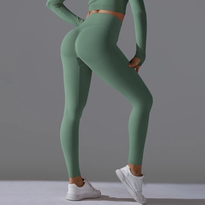 Detail of high-waist seamless yoga set in sage green showing thumb holes and lift design