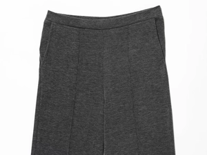 Detailed close-up of dark grey ribbed knit pants featuring an elastic waist and side pockets