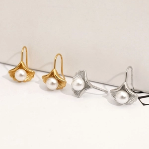 Elegant 316 stainless steel ginkgo leaf earrings with white pearl detail in gold and silver