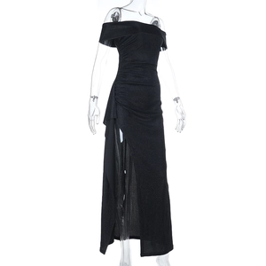 Detail of a sparkling black off-shoulder maxi dress featuring a high side slit design