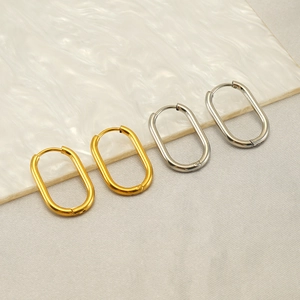 Detailed view of minimalist oval hoop earrings in polished gold and silver steel finish