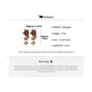 Detailed view of leopard print fabric flower earrings with 14cm size and 9.1g weight info