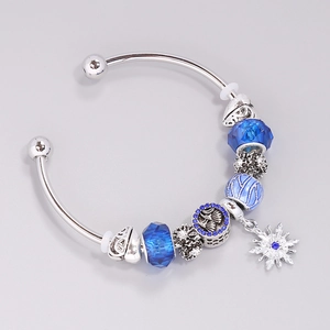 Silver charm bracelet with ocean blue glass beads and a delicate snowflake pendant charm