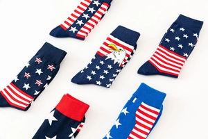Detail view of six pairs of American flag cotton crew socks with stars and eagle patterns