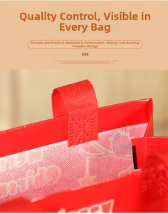 Detail of reinforced cross-stitching on the handle of a red Christmas gift tote bag