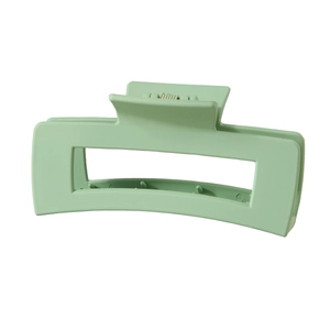 Close-up of a large rectangular light green matte hair claw clip in a minimalist style