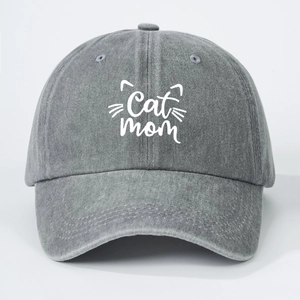 Close-up of Cat Mom embroidery and kitten whiskers on washed grey cotton baseball cap