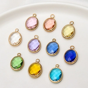 Macro shot of 10x12mm colorful oval crystal charms with gold-plated metal frame edges
