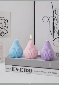 Macro detail of three geometric pear-shaped scented candles with textured diamond pattern