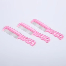 Three pink hairbrushes with stainless steel pins and decorative hollow handles on a white background
