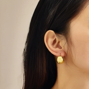 Elegant gold pebble-shaped stainless steel earrings with a polished mirror finish