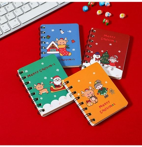 Set of four Christmas spiral notebooks with festive Santa and reindeer designs