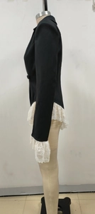Detail of black blazer with beige lace patchwork on hem and cuffs on a mannequin