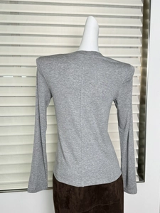 Slim fit grey long sleeve top back view with padded shoulders on a mannequin