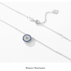 Macro detail of S925 sterling silver evil eye pendant necklace with blue and white zircons