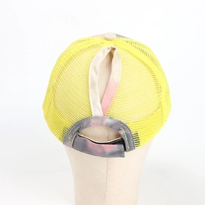 Detail of ponytail hole and tie-dye velcro strap on breathable yellow mesh baseball cap