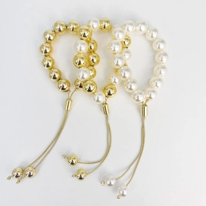 Three elegant pearl and gold ball beaded bracelets with adjustable slide chains for women