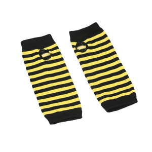 Detail of yellow and black striped knit arm warmers with thumb holes on white background