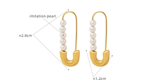 Detailed view of paperclip style gold earrings with pearls, size 2.8cm by 1.2cm