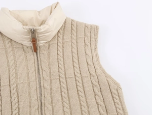 Close-up of beige knit vest featuring cable texture and nylon拼接 stand collar with zipper