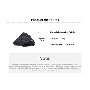 Detailed view of navy tweed bow hair claw clip with golden button and acrylic base