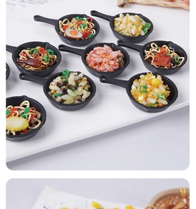 Macro detail of miniature frying pans with realistic resin food models and tiny ingredients