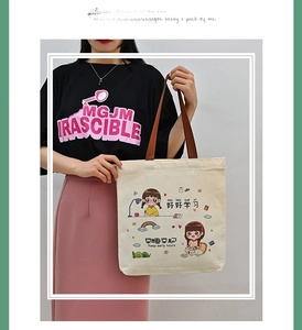 Detail of canvas tote bag with brown handles and cute girl illustration print