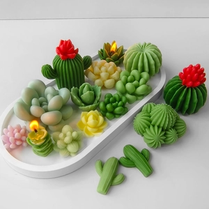 Artistic arrangement of assorted colorful cactus and succulent shaped wax candles on a tray