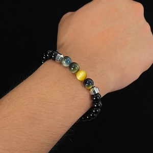 Detailed macro view of black beads bracelet with tiger eye stones and silver spacers