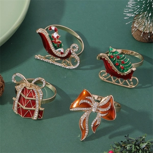 Detail of 4-piece gold metal Christmas napkin rings with enamel and rhinestones set
