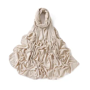 Detail of soft jersey cotton scarf in beige featuring fine stitched edge finish