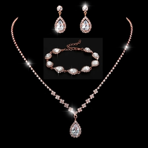 Detailed macro view of bridal jewelry set with pear-shaped cubic zirconia in rose gold