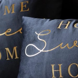 Detail of dark velvet pillow cover with gold foil Sunshine lettering and soft texture