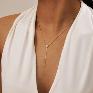 Elegant gold heart zircon Y-necklace on a model, minimalist chic pendant style