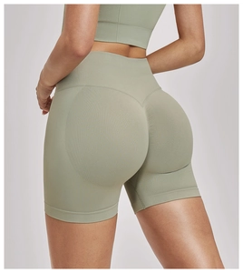 Detail showing high-waisted seamless ribbed waistband and olive green knit fabric