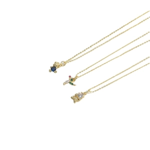Trois colliers dorés avec pendentifs ours bleu, oiseau et géométrique sur fond blanc