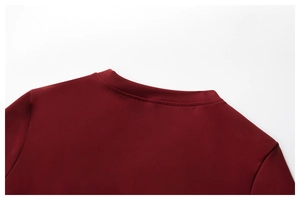 Close-up of the reinforced crew neck and smooth burgundy knit fabric of this yoga top