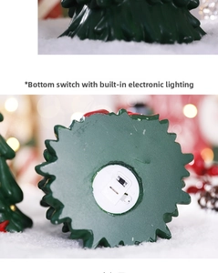 Detail view of the bottom power switch and LED light component on resin Christmas tree