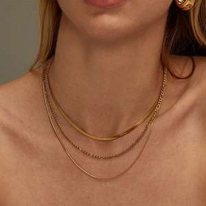 Three-layer gold stainless steel necklace set with flat snake and Figaro chain styles