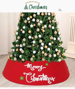 Detail of red fabric Christmas tree skirt with Merry Christmas text and white snowflakes