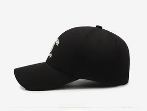 Detailed side view of black cotton baseball cap with white letter embroidery details