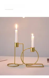 Detail of champagne gold geometric metal candle holder with white spiral candles