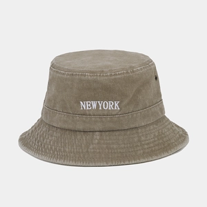 Close-up of vintage washed khaki cotton bucket hat with white NEWYORK embroidery detail