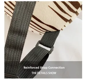 Close-up of reinforced shoulder strap stitching on zebra print plush kids backpack
