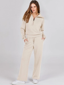 Detail of beige half-zip collar sweatshirt and matching drawstring wide-leg knit trousers